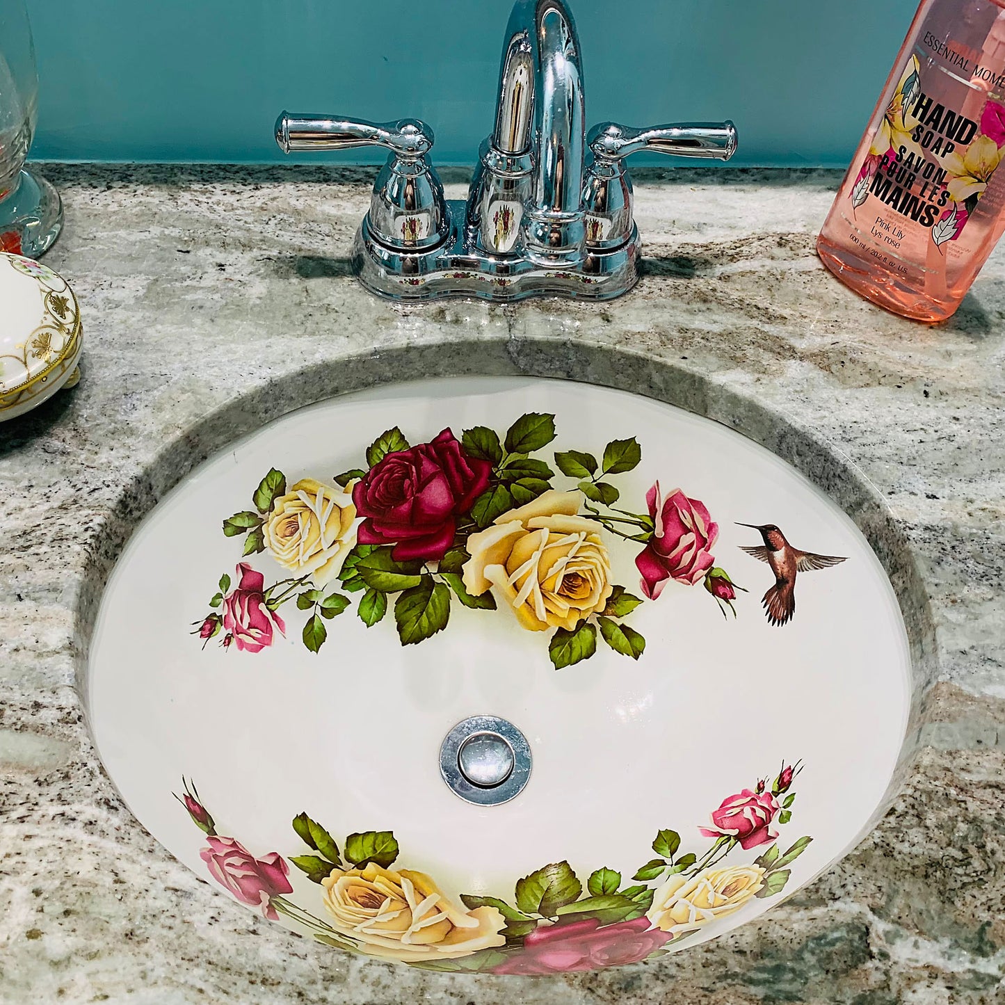 Custom bathroom with roses painted sink and hummingbird