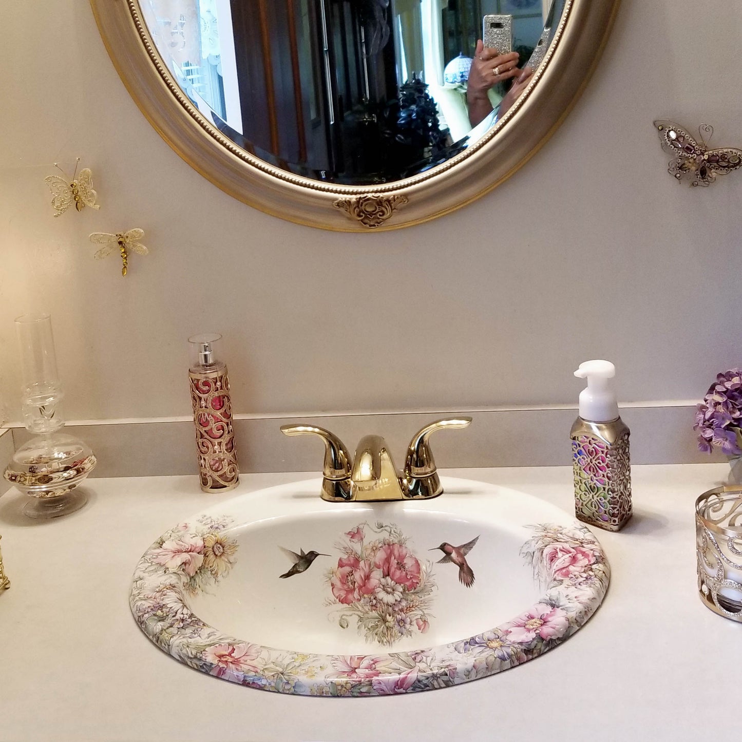 White bathroom with Elegant gold accents and Rococo flowers painted sink