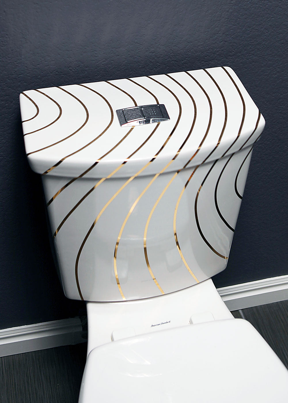 modern toilet in blue powder room painted with gold swirling lines design