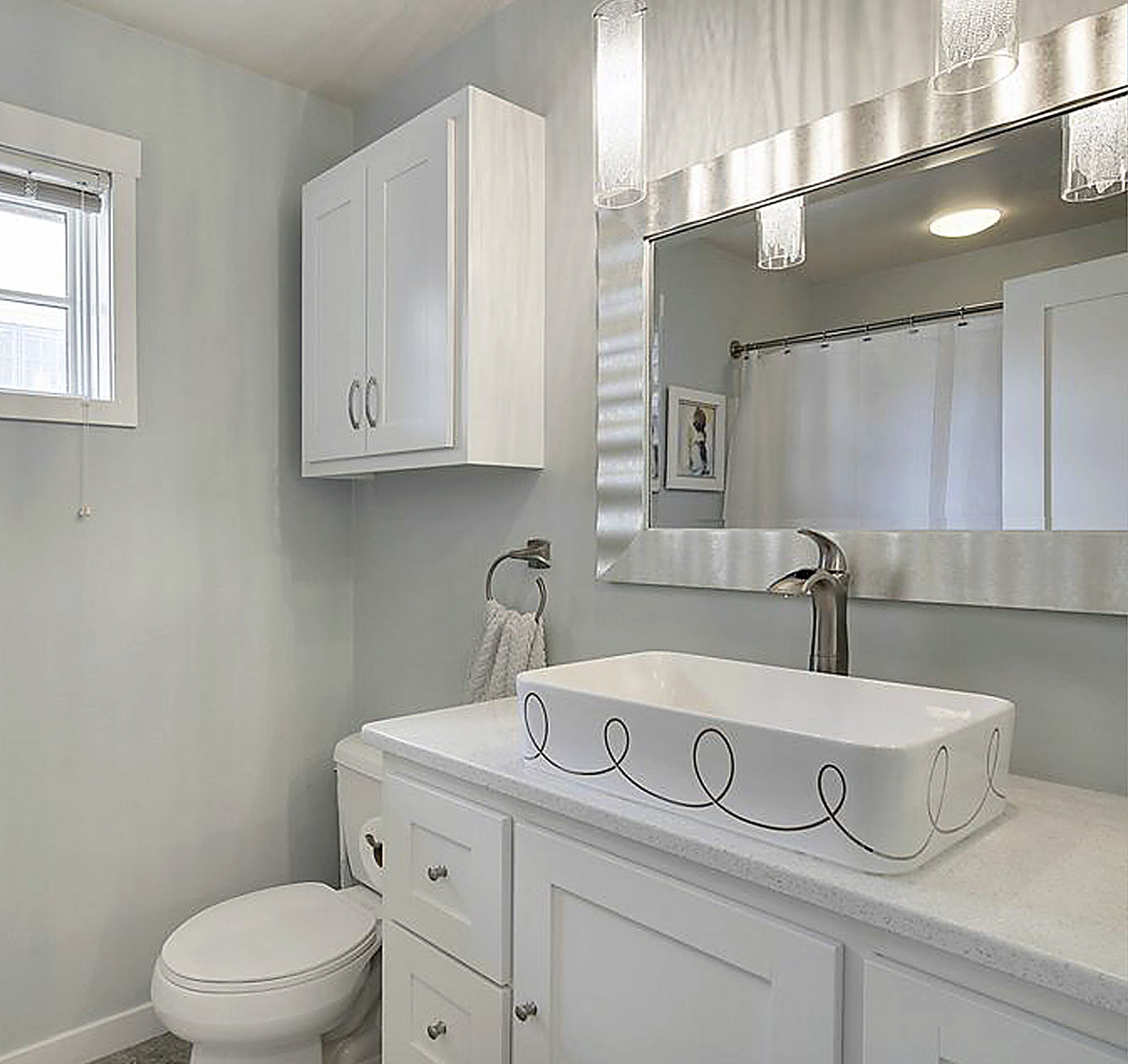 Modern guest bathroom with silver loops painted rectangle vessel sink and silver mirror