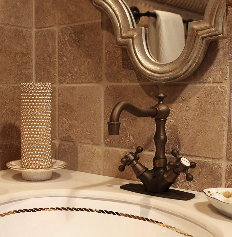 beige tumbled stone bathroom with gold rope border painted sink