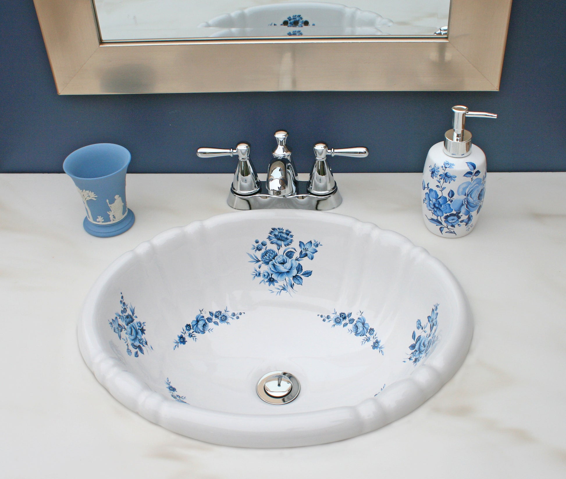Navy blue powder room with Edgewood accents and blue roses painted sink