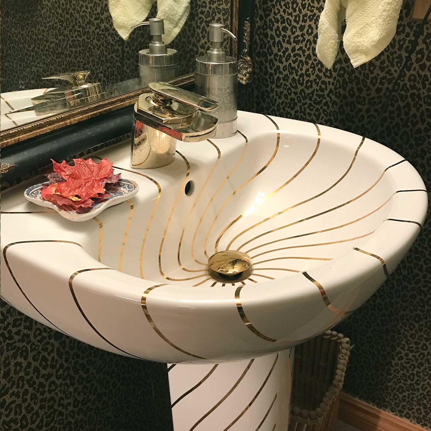 Leopard wallpaper bathroom with beautiful gold swirling lines pedestal sink