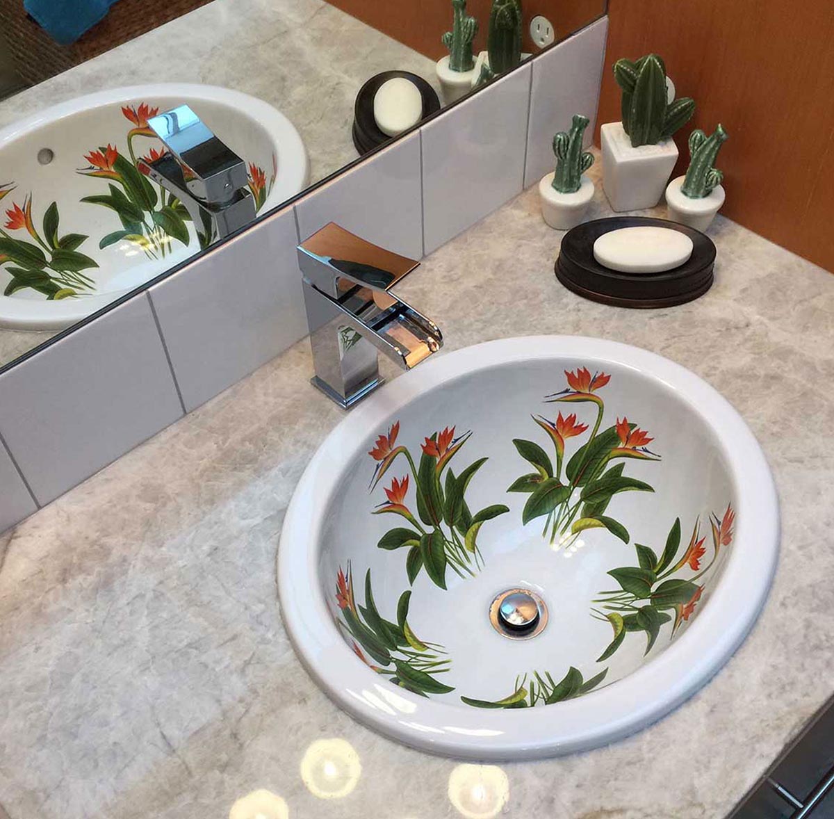 Beautiful southwestern bathroom featuring bird of paradise flowers decorated bathroom sink
